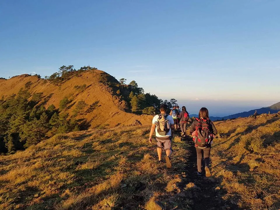 Open grassland campsite near the Mt. Ulap summit with tents pitched at dawn