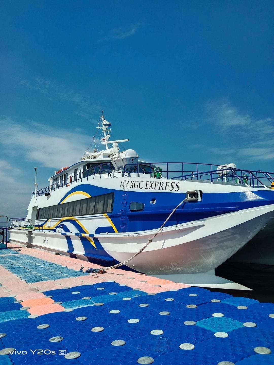 Passenger ferry crossing Manila Bay toward Camaya Coast with the Bataan mountains visible in the background
