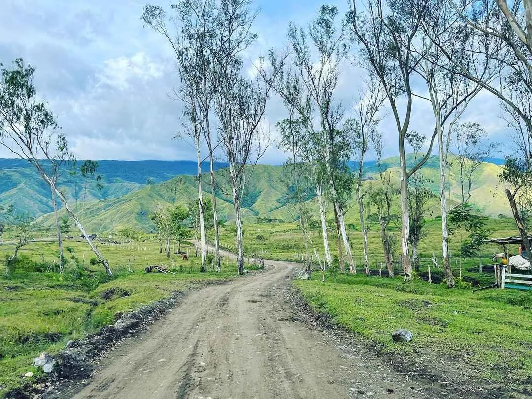 Habal-habal motorcycle on the dirt trail leading into Communal Ranch Bukidnon