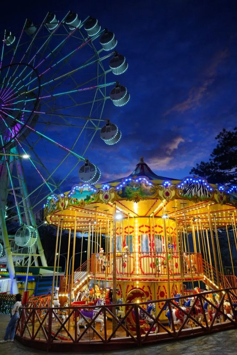 Baguio Eye ferris wheel at Skyranch Baguio rising above the SM City Baguio rooftop at sunset