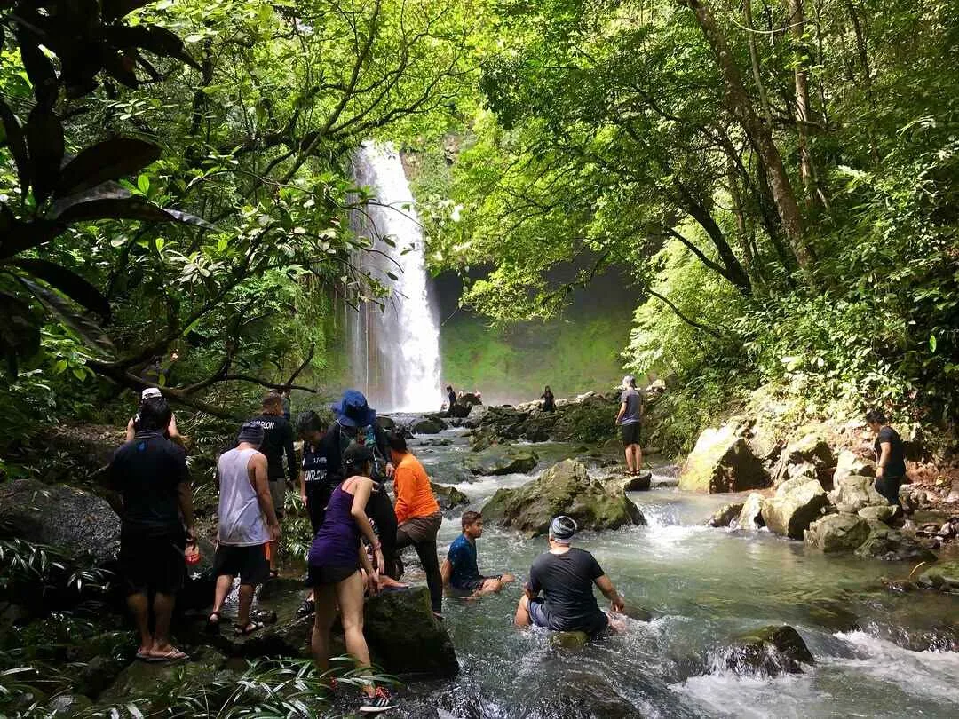 Multi-tiered Buruwisan Falls cascading over mossy rock walls into a clear pool in Siniloan, Laguna