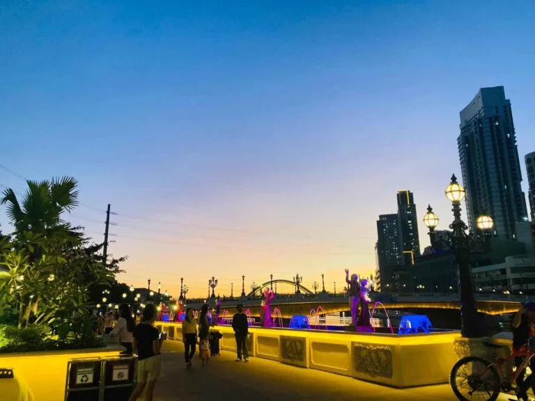 Esplanade Food Bazaar open-air stalls at night with illuminated Binondo-Intramuros Bridge visible