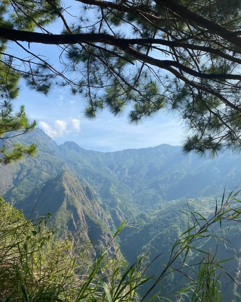 Rest shed and water source midway up the Mt. Kabunian trail with Mt. Tenglawan visible in the background