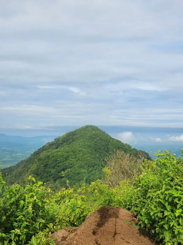 Panoramic summit view from Mt. Talamitam in Nasugbu trilogy showing vast cogon grasslands and distant mountain ridges under a bright sky