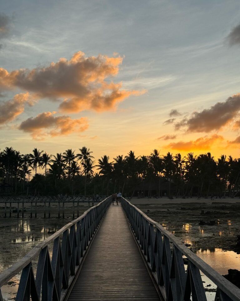Wide-angle view of Cloud 9 siargao reef break from the wooden boardwalk, General Luna, Siargao Island, with surfers in the water below