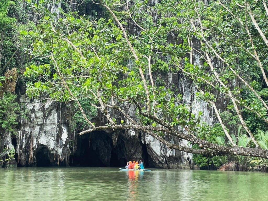Motorized bangka approaching the cave mouth of the Puerto Princesa Underground River at Sabang Beach