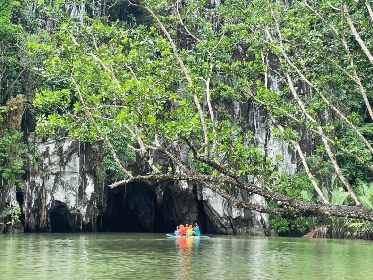 Motorized bangka approaching the cave mouth of the Puerto Princesa Underground River at Sabang Beach