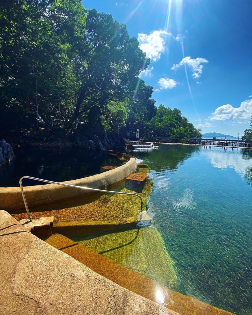 View of limestone islands across Coron Bay from the elevated wooden deck at Maquinit Hot Springs