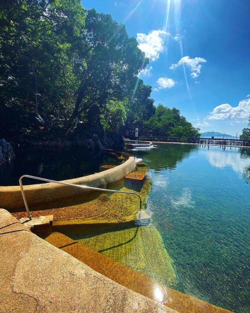 View of limestone islands across Coron Bay from the elevated wooden deck at Maquinit Hot Springs