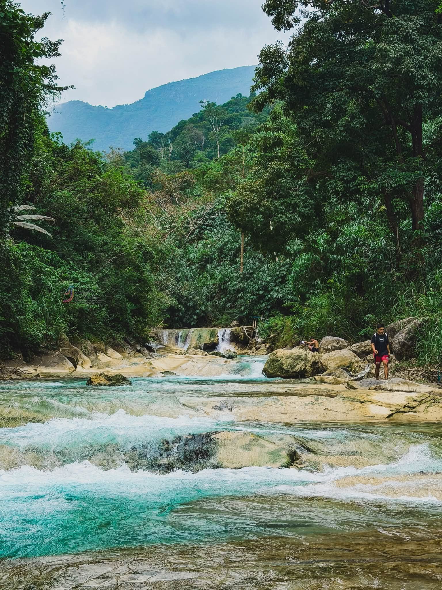 Lablabasan River flowing through Barangay Alfonso with clear blue water and forested canyon walls in Gregorio del Pilar, Ilocos Sur