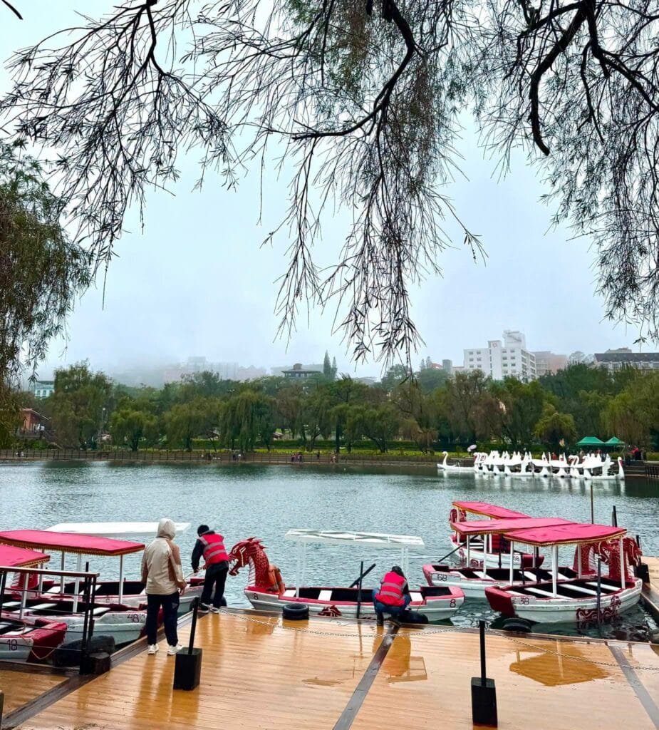 Burnham Park entrance and lakeside promenade with pine trees and open walkways in Baguio City