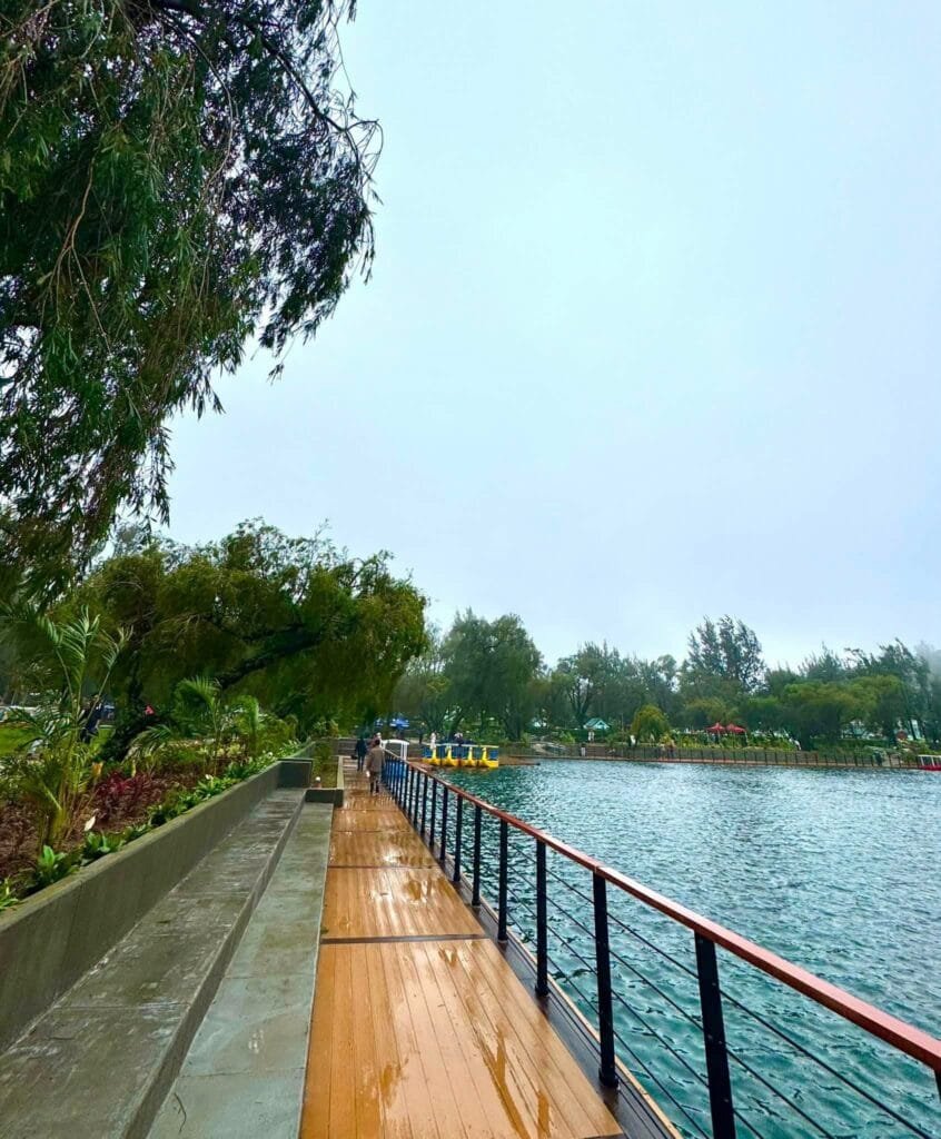 Burnham Park entrance and lakeside promenade with pine trees and open walkways in Baguio City