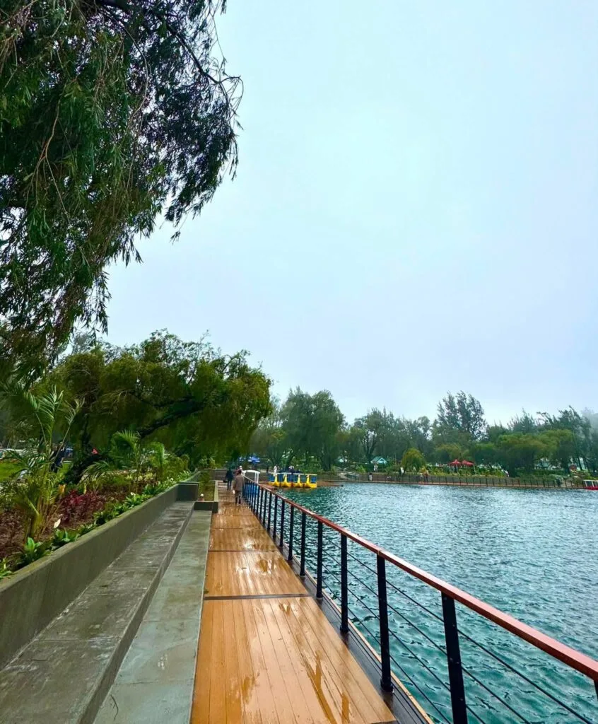 Burnham Park entrance and lakeside promenade with pine trees and open walkways in Baguio City