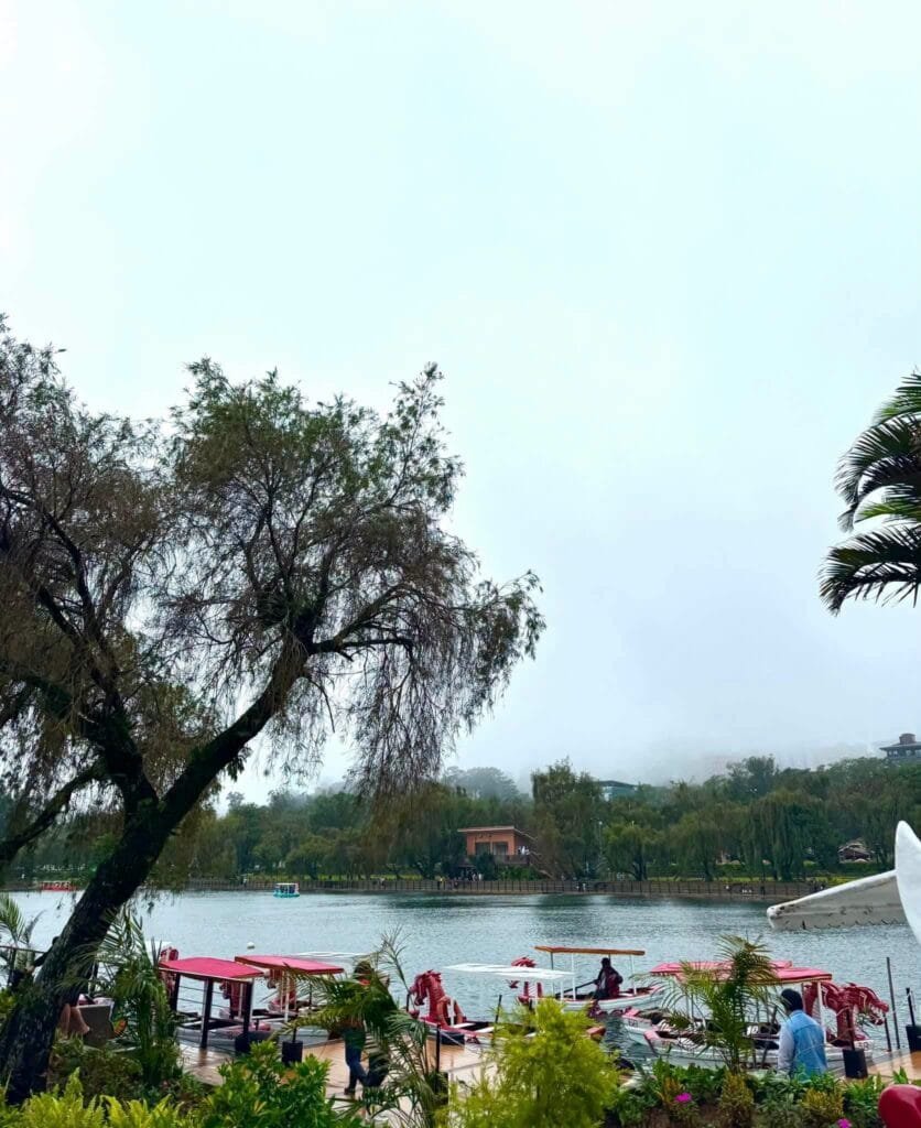 Burnham Park entrance and lakeside promenade with pine trees and open walkways in Baguio City