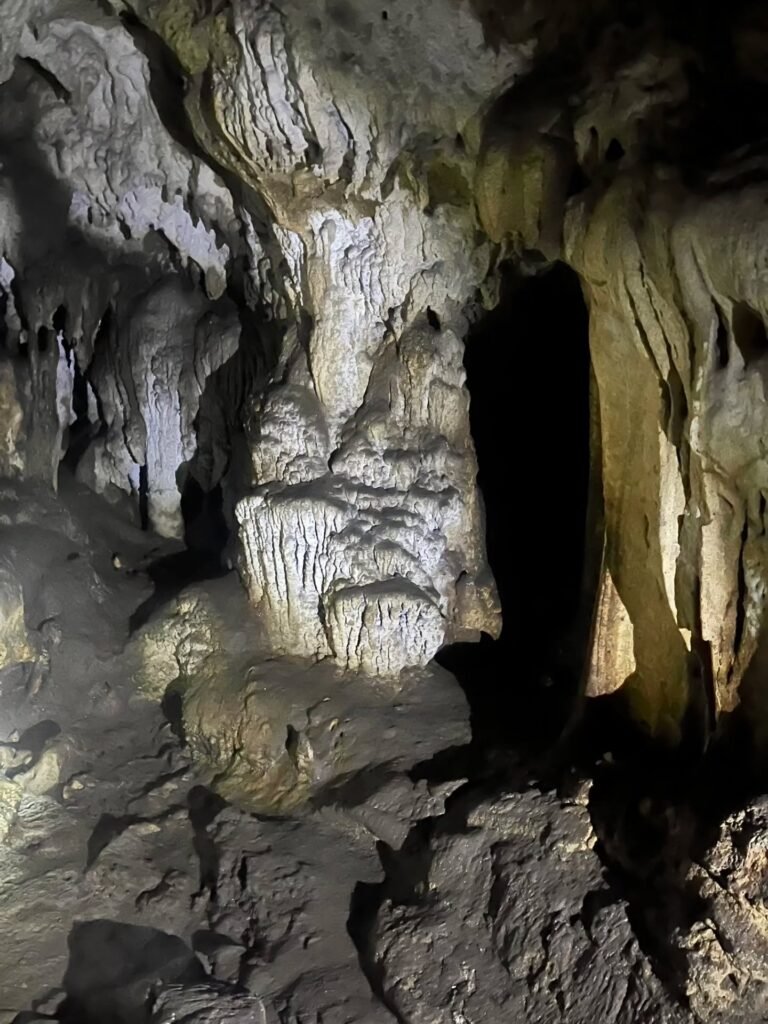 Deep natural gorge pool with limestone canyon walls after exiting the Jovellar Underground River cave