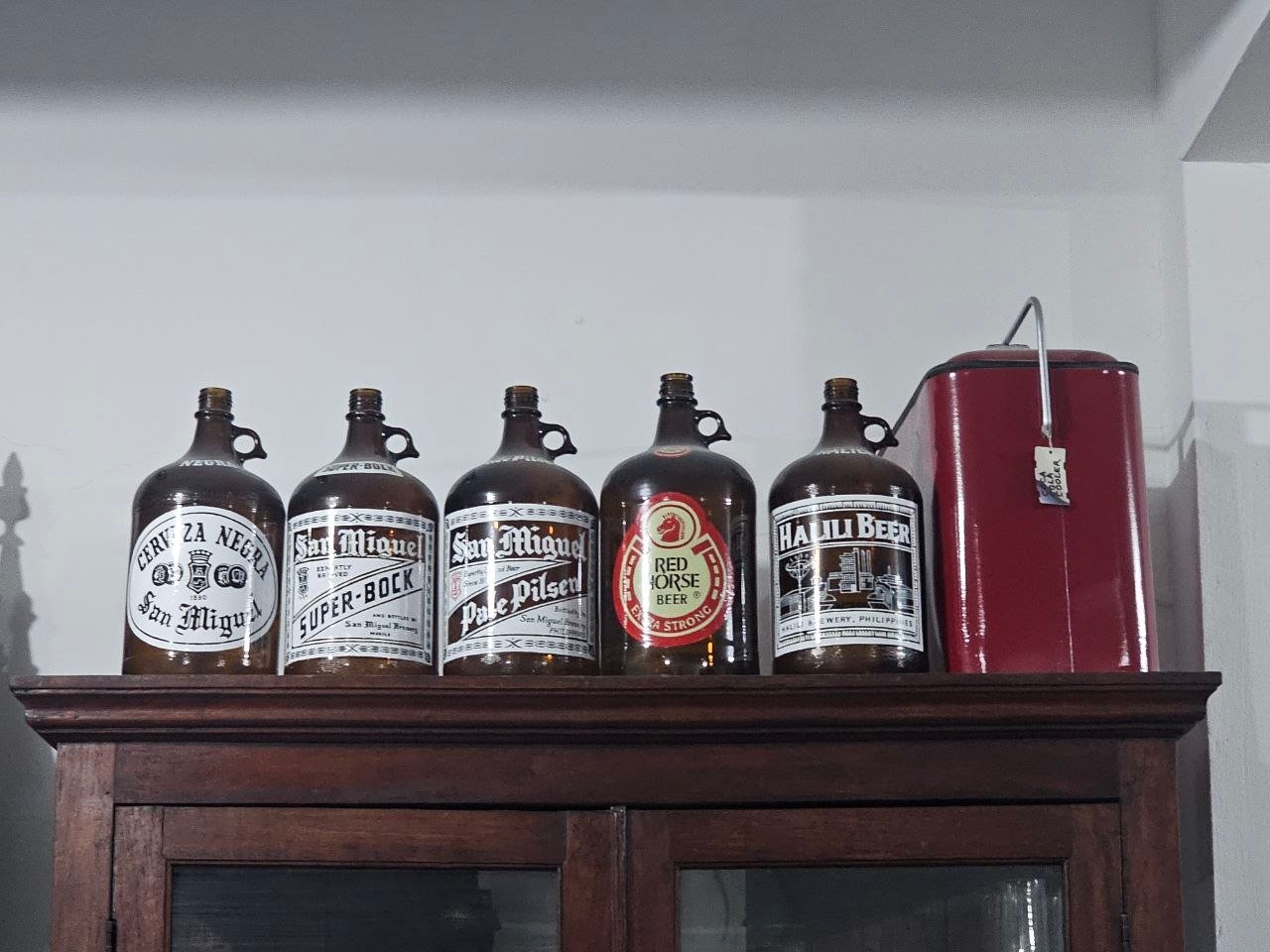Vintage Bottles of San Miguel Beer and Halili Beer and a Red Metal Cooler