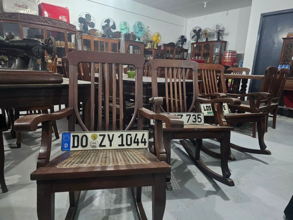 Vintage Wooden Rocking Chairs and Licenses Plates in Front